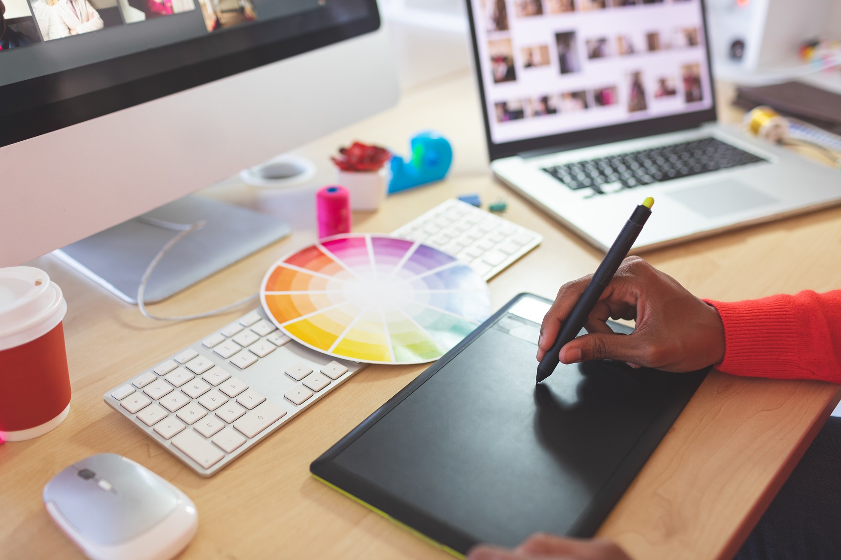 Graphic workstation and a person's hands working on Track-pad