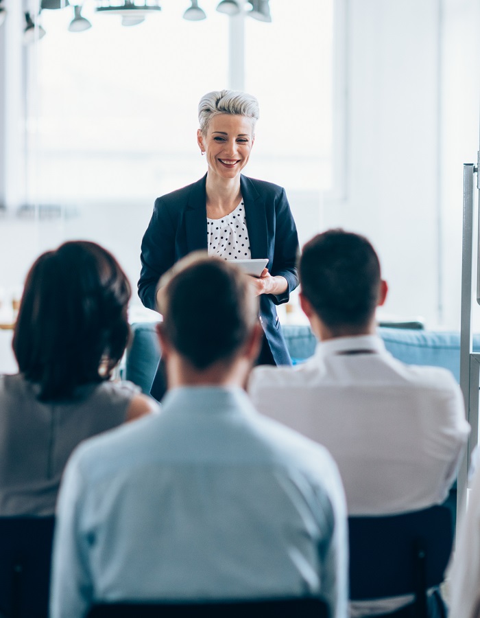 Person standing in front of a room facing sitting students