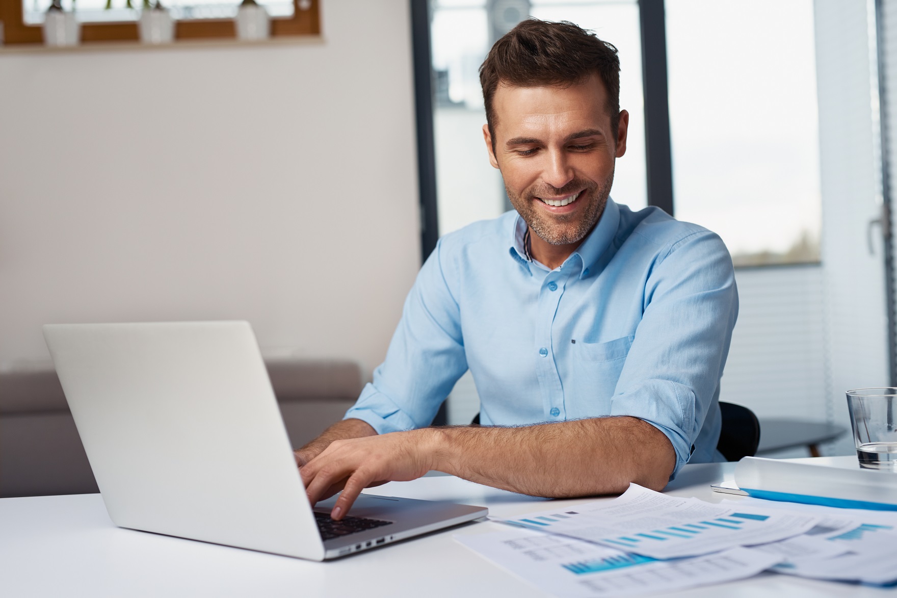 Man doing data entry job at laptop