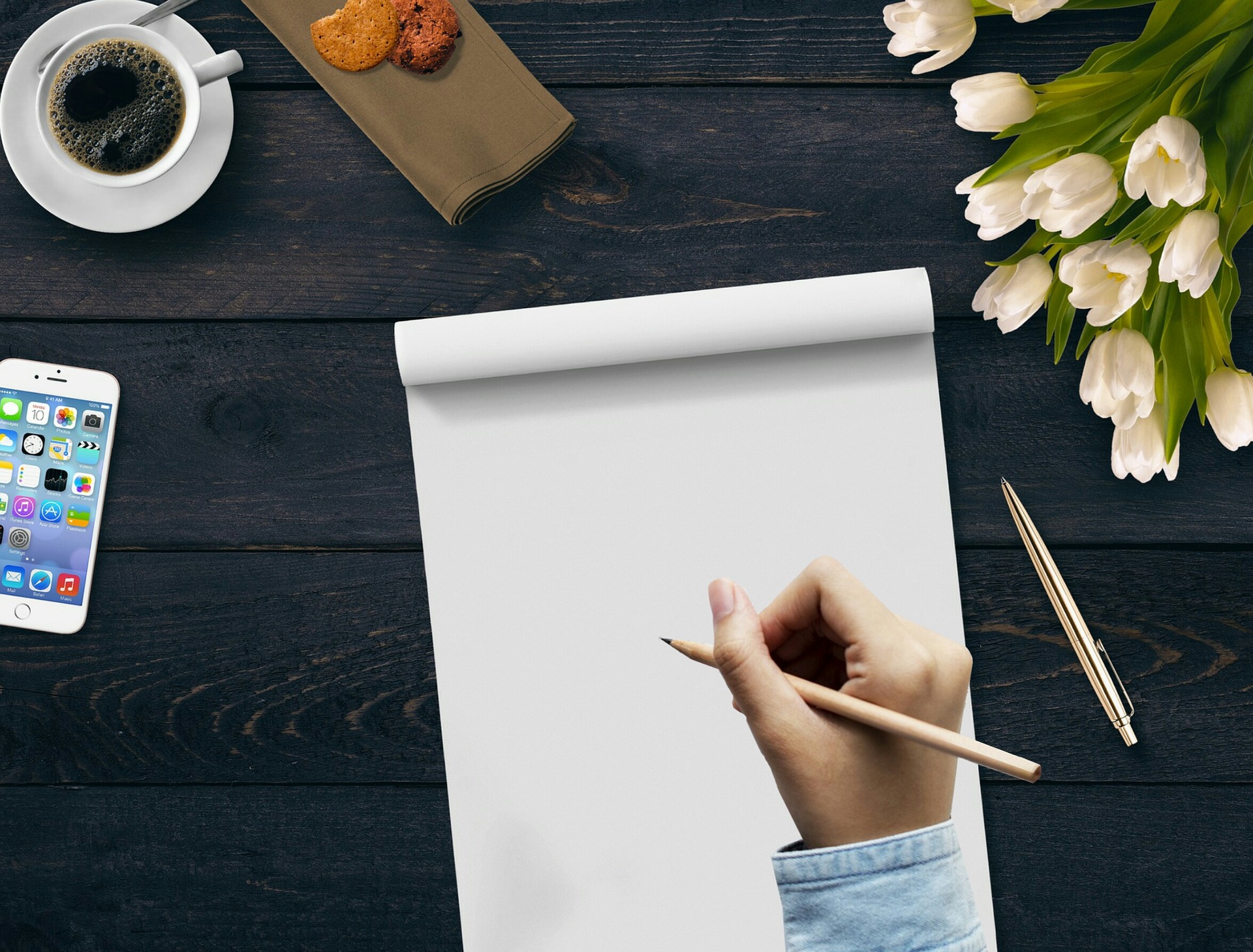 A man holding a pencil to write content on the paper